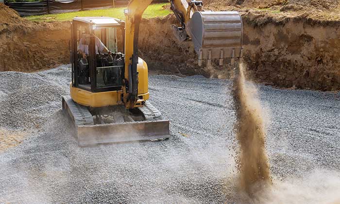 Land grading and levelling with an excavator